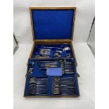 A near complete comprehensive 12 place setting oak canteen of silver plated cutlery including nut
