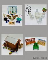 A collection of dolls house accessories relating to the garden including benches, porch swing, table
