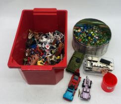 A collection of miscellaneous toys including domino's marbles, die-cast vehicles, plastic toys