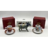 A boxed Cow Parade ceramic figurine with multi coloured design along with two boxed Goebel Rosina