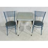 A retro Formica topped kitchen table with two bistro style chairs