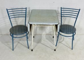 A retro Formica topped kitchen table with two bistro style chairs