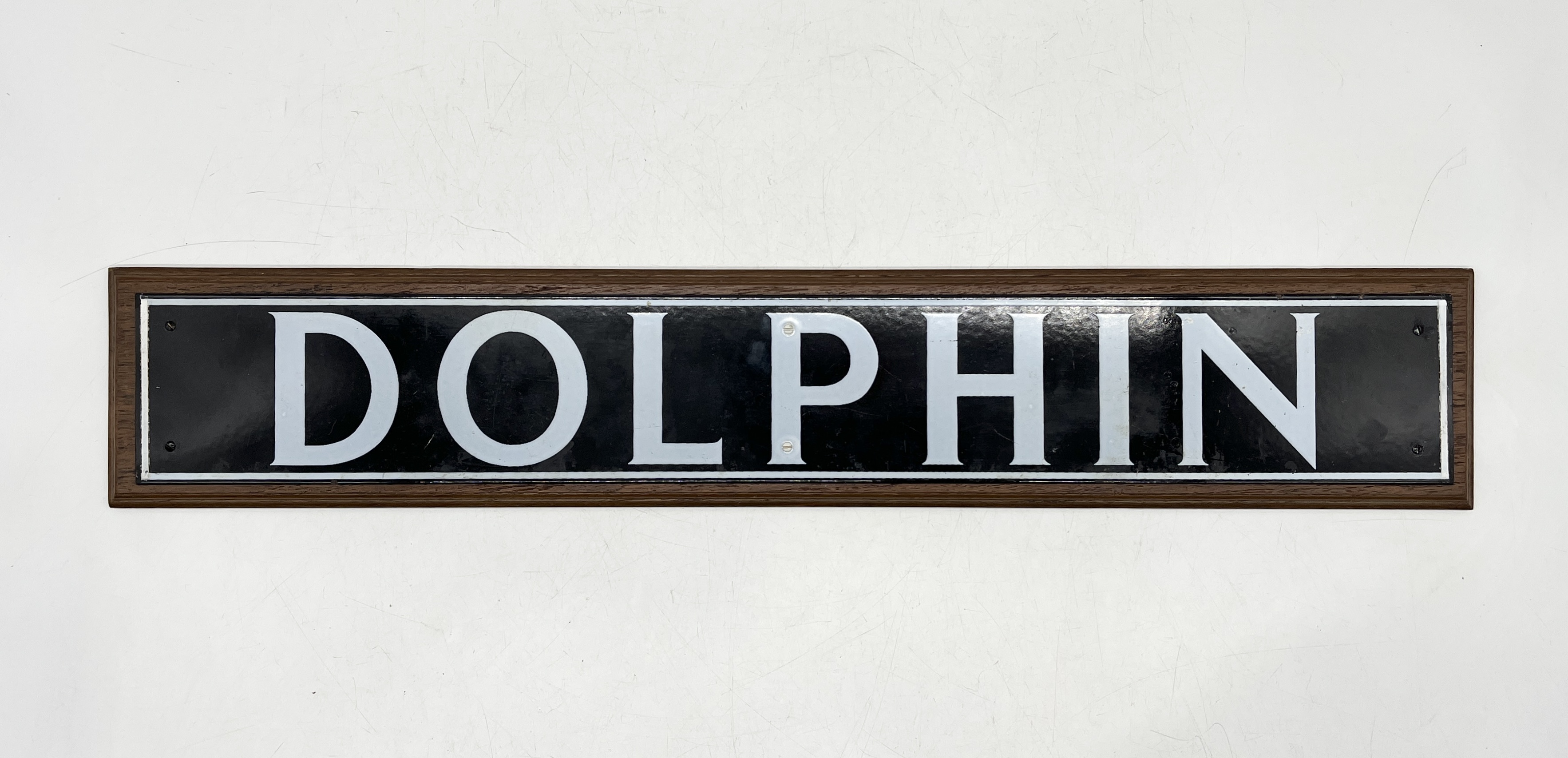 A modern enamel "Dolphin" sign mounted on wooden board - 74cm x 14cm