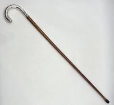 A turn of the century walking stick with continental silver handle