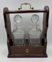 A modern two bottle tantalus with decanters