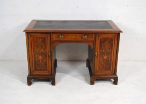 An Edwardian inlaid mahogany kneehole writing desk, with black leather inset top, with single drawer