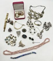 A collection of costume jewellery etc. including a reverse painted brooch, cameo, watches etc.