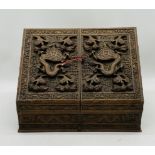 An Oriental heavily carved hardwood stationary box, with key - length 44cm, depth 24cm, height 31cm