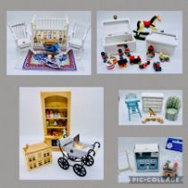 A collection of dolls house furniture relating to a nursery including a cot, bookcase with toys,