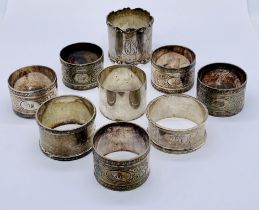 Four hallmarked silver napkin rings along with 5 silver plated versions