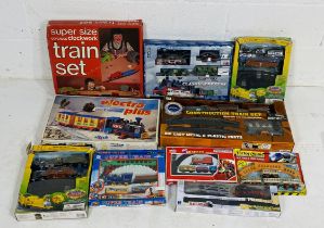 A collection of boxed children's train sets including supersize OO gauge clockwork train set,