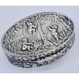 A Sterling silver pill box with repousse decoration