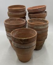 A collection of twenty-three vintage terracotta pots