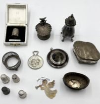A collection of hallmarked silver items including a Victorian lidded box, shell shaped salt with