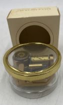 A boxed Reuge Music paperweight music box