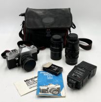 A Praktica MTL3 camera with carry case, two lenses and other accessories