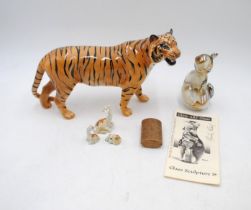 A Beswick figure of a tiger, along with a Glory art glass figure of a cat signed by Martin Evans,