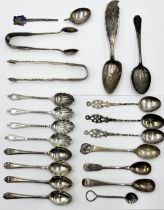 A collection of hallmarked and continental silver spoons, sugar tongs etc. total weight 272.6g