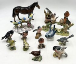 A collection of Beswick and Staffordshire birds, horses etc.