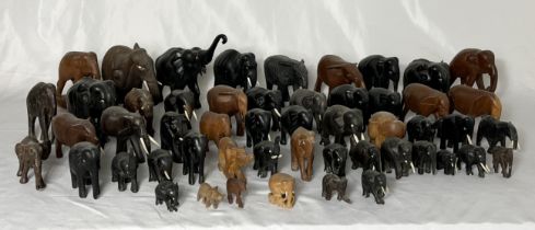 A large collection of wooden elephants, most A/F