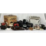 A collection of vintage cameras and camera equipment including Konica Pop, Pentax, Eumig etc.