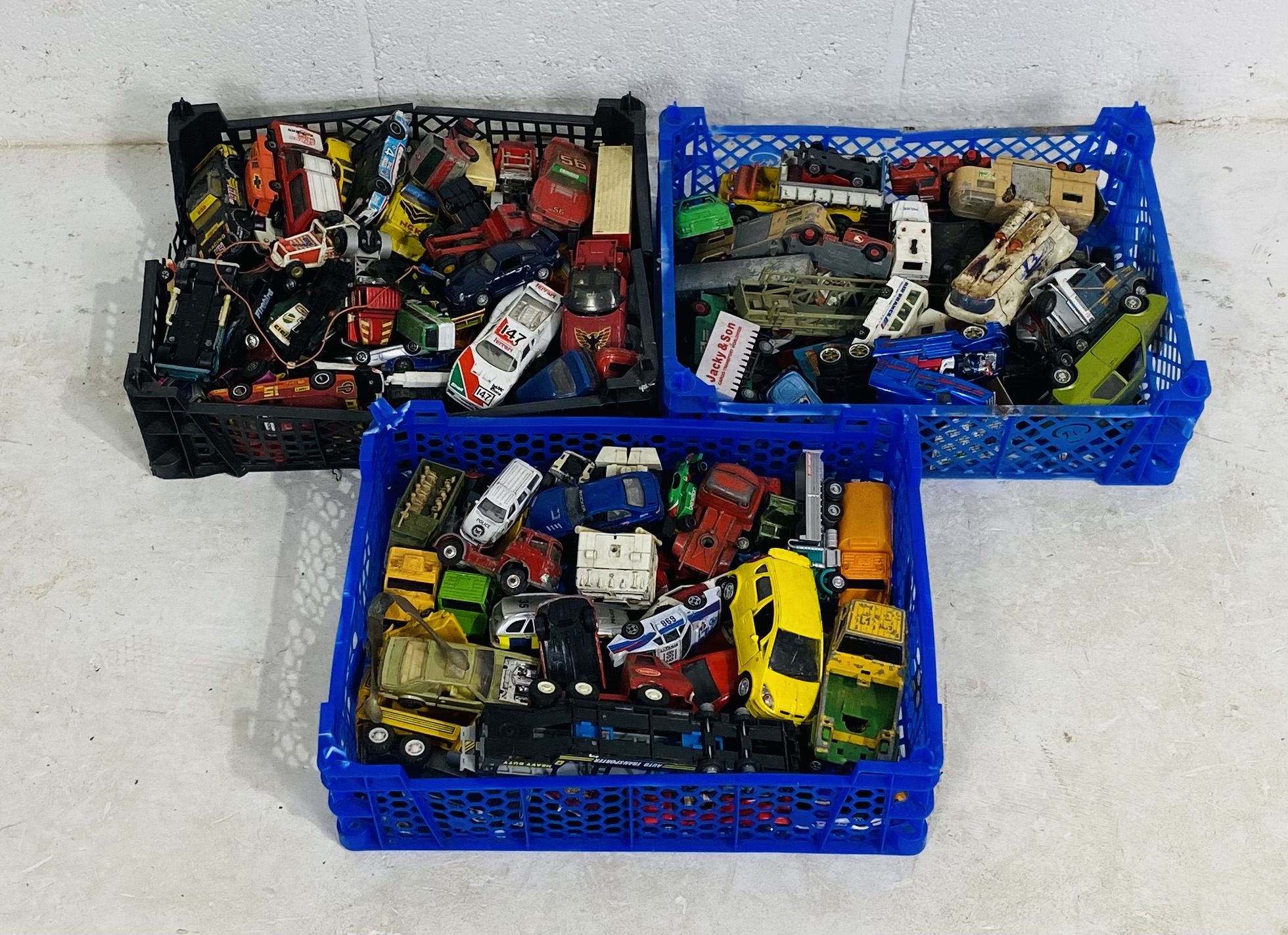 Three small crates of playworn die-cast vehicles including Matchbox, Lesney, Burago, Corgi Toys,