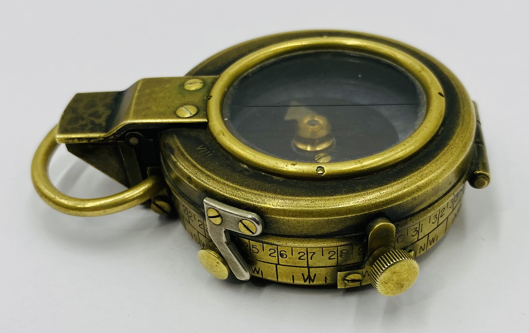 A WW1 military brass compass, marked with a broad arrow mark and 1917 to reverse