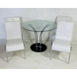 A 1980s style glass topped chrome dining table with four white vinyl chairs. Diameter 96cm