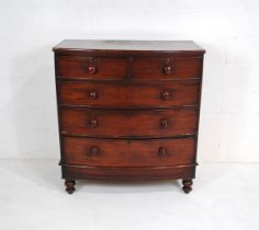 A Victorian mahogany bow-fronted chest of five drawers, raised on turned legs - one leg loose but