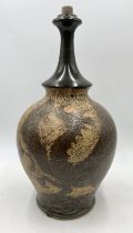 A pottery lamp base decorated with dragon motif