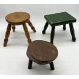 A collection of three small rustic stools