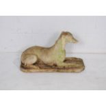 A reconstituted stone figure of a greyhound - length 68cm, height 40cm