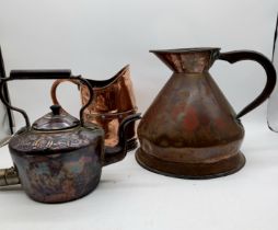 An antique copper large jug with VR seal along another similar and copper kettle with "Good Luck"