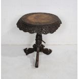 An Anglo Indian heavily carved and pierced circular hardwood table, raised on tripod base with