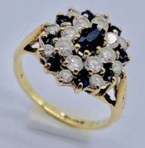 A 9ct gold ring set with sapphires and clear stones, size I 1/2