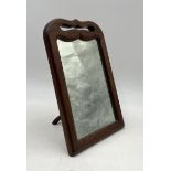 An antique mahogany framed freestanding vanity mirror