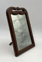 An antique mahogany framed freestanding vanity mirror