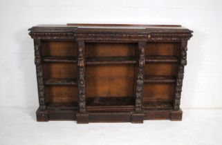 A turn of the century heavily carved oak break-fronted bookcase - some parts loose but present -