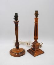 A wooden table lamp with fluted column decoration, along with another wooden table lamp