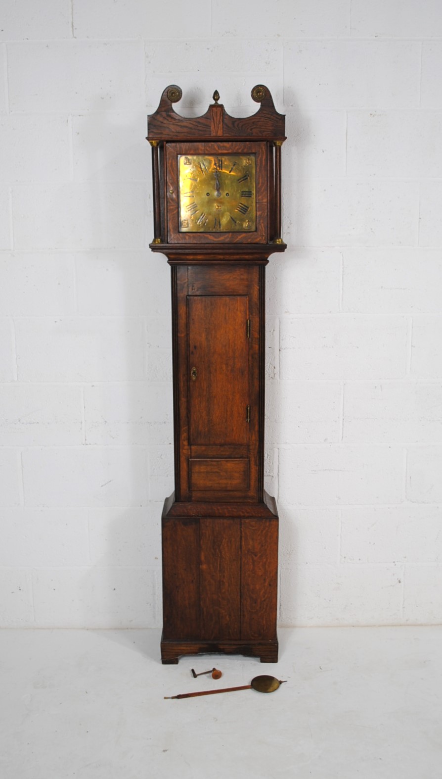 A Georgian oak chiming longcase clock, with brass dial decorated with Egyptian motifs, with fusee