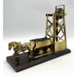 A mounted brass colliery pit pony and carriage ornament.