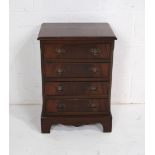 A Georgian style mahogany bedside chest of four drawers, raised on bracket feet - length 44.5cm,