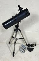 A Celestron AstroMaster 130 telescope with accessories and instructions