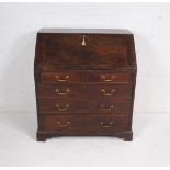 A Georgian mahogany bureau, with five drawers with brass handles, raised on bracket feet, with