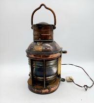A vintage copper ship's lantern with makers label and converted to electricity - not tested.