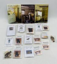 A collection of Model Village miniatures 1;24th size along with three books by Fiona Broadwood.