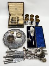 A collection of various silver plated items including set of six tumblers, serving set, cutlery