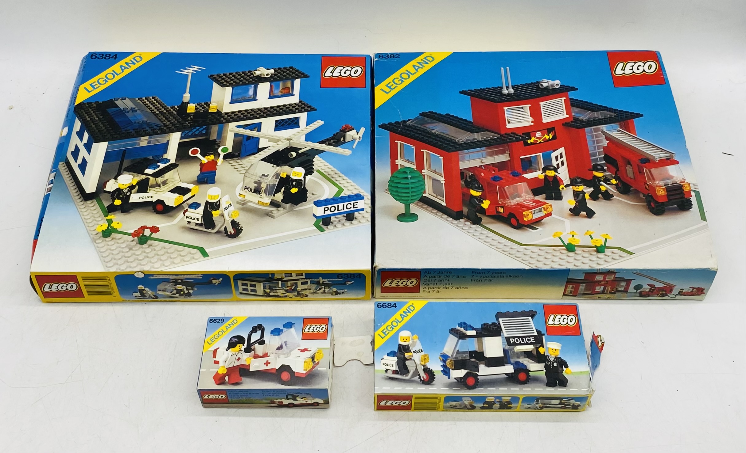 Four boxed 1980's Lego Legoland sets including Fire Station (6382), Police Station (6384) Police