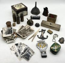 A collection of various items including trench art, vintage postcards and photographs including