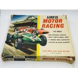 A boxed vintage 1960's Airfix Motor Racing set (1:32 scale) including two cars, barriers,